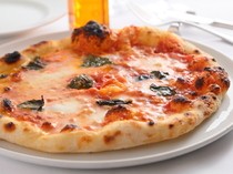  [Pizza Margherita] with a chewy dough topped with melting Mozzarella. Enjoy the authentic taste of Naples! 