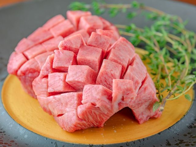 Savoring carefully selected aged meat and wine, enjoying a luxurious moment in an adult hideaway.