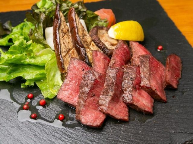 Savoring aromatic wood-fired dishes while gazing at the flickering flames.