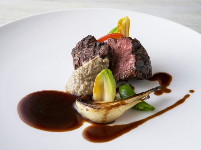 A casual French restaurant surrounded by greenery and light