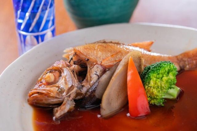 Savor the taste of fish dishes that evoke the richness of nature in a serene Japanese setting.
