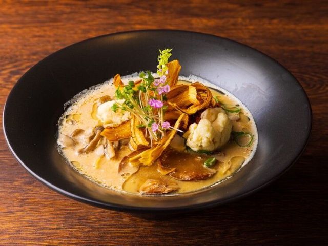 Savor the richness, umami, and satisfying texture of plant-based ramen at this specialty shop.
