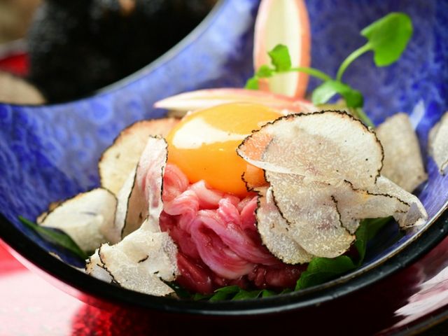 Indulge in the exquisite taste of premium grilled meat and raw beef in an elegant, extraordinary setting