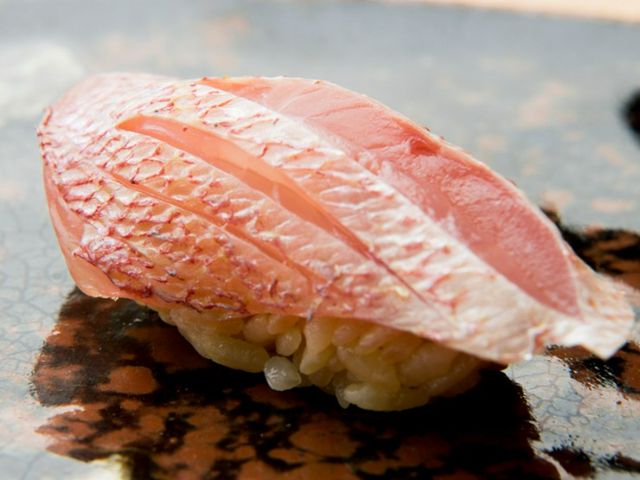 Sushi featuring seasonal fish from Kyushu and local sake, enjoyed at the counter