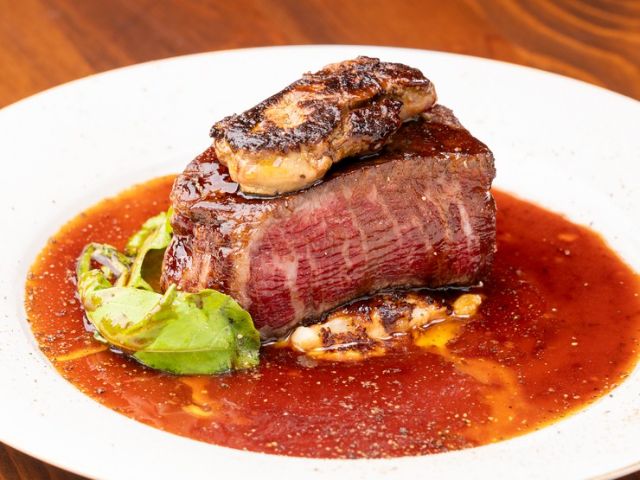 Savor black wagyu beef in a dining area adorned with murals of spring, summer, autumn, and winter.